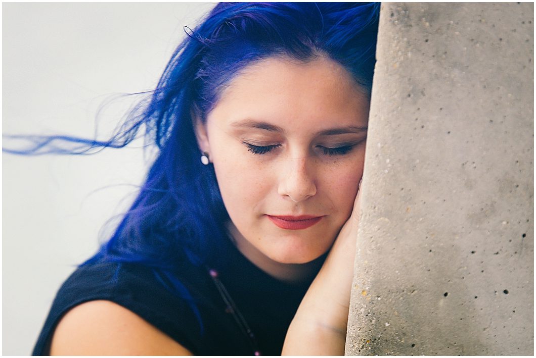 High School senior girl with blue hair poses for senior portraits in sarasota FL