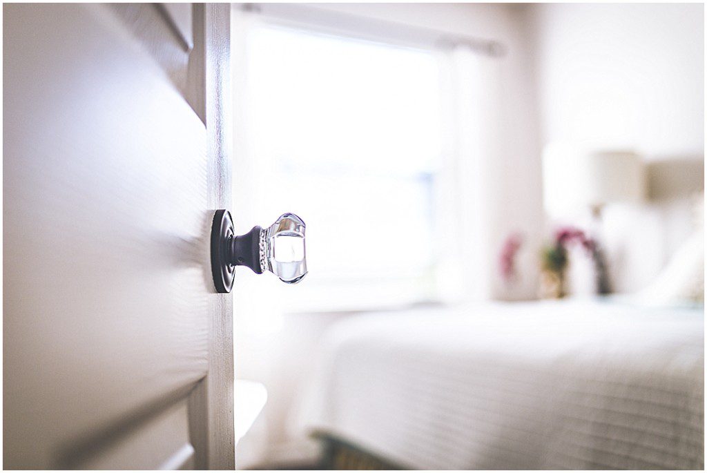 Beautiful crystal doorknob in bright light filled white room in this photo of Sarasota Real Estate Photography.