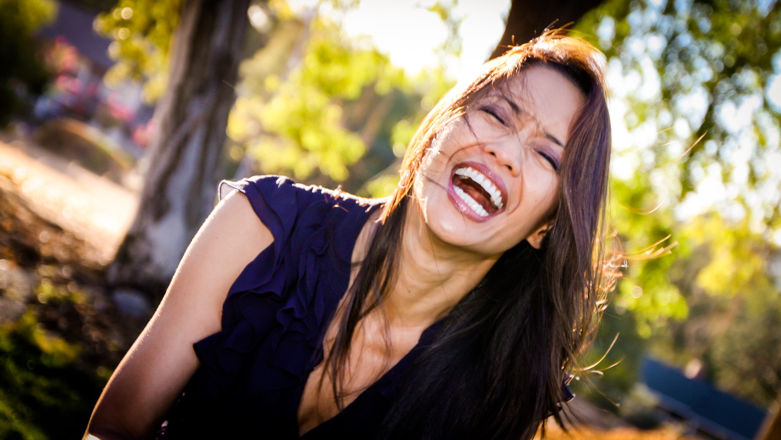 Woman laughing candidly outdoors during a branding headshot session in Sarasota