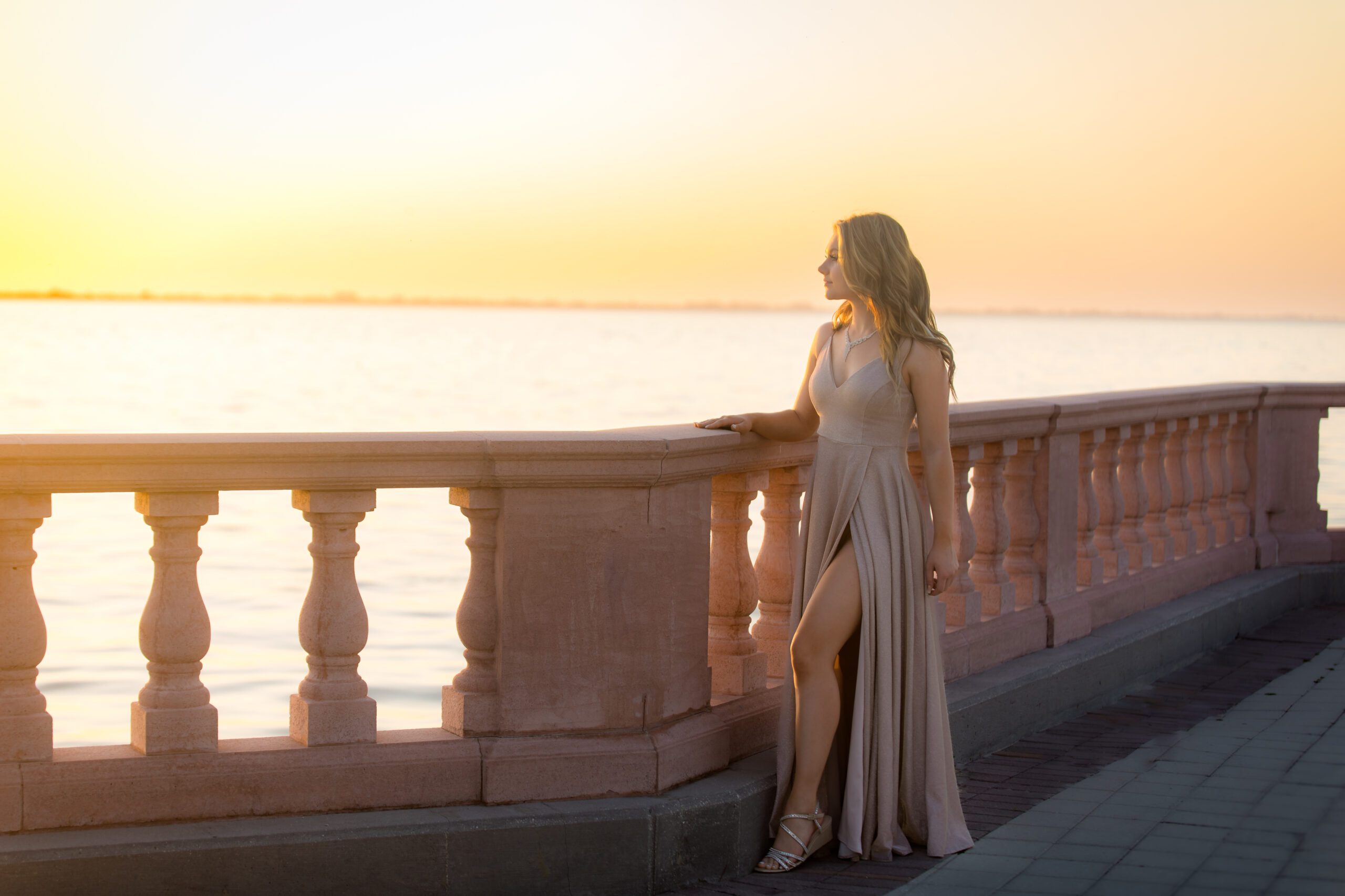 Glamorous Sarasota senior portrait at sunset overlooking the water, photographed by Ristaino Photography