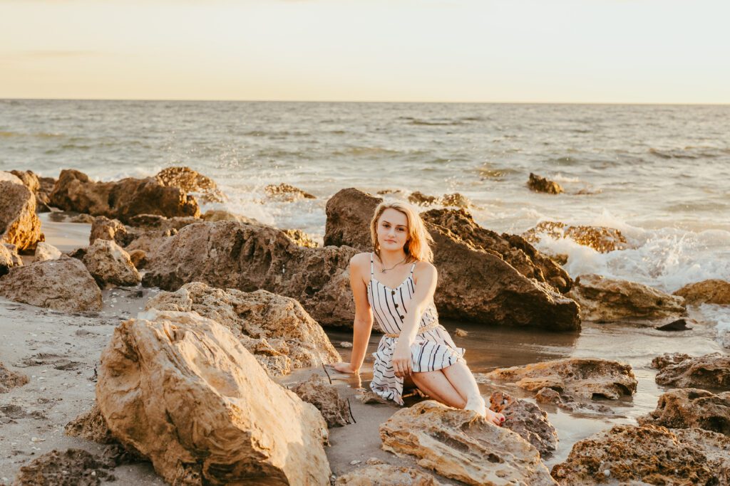 Senior portrait at Caspersen Beach Venice Florida, dramatic rocky shoreline, Ristaino Photography