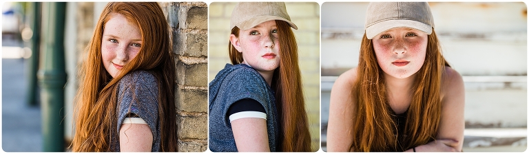 Teen aged girl with red hair and freckles and green eyes wearing a baseball cap 