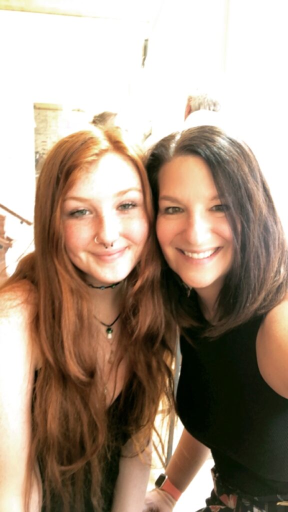 Photographer and now-teen Lola smiling together in a warm, full-circle moment — a decade after their first photo session.