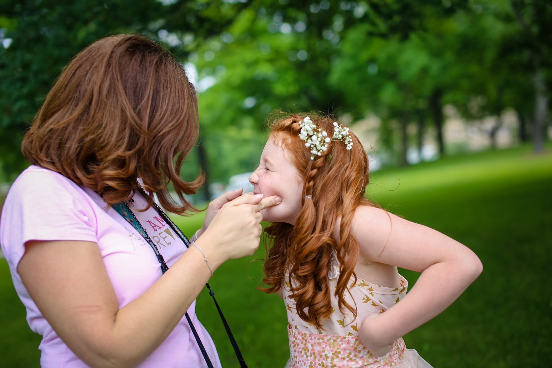 Photographer and young girl laughing together during a behind-the-scenes moment at their first photo session — the beginning of a 10-year se