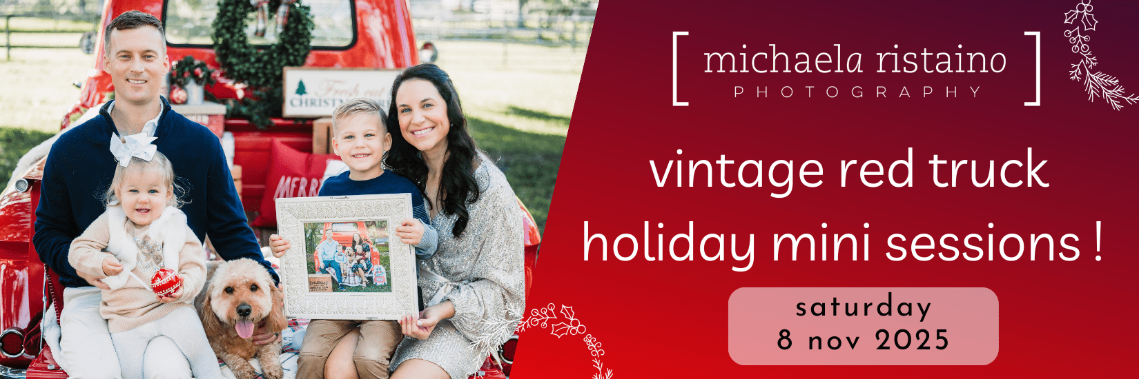 A smiling family of four with their dog sitting on the back of a vintage red truck decorated for Christmas. The parents sit on each side with two young children in the middle, one holding a framed photo. Holiday greenery decorates the truck. Text on the right reads: ‘Michaela Ristaino Photography – Vintage Red Truck Holiday Mini Sessions! Saturday, 8 Nov 2025