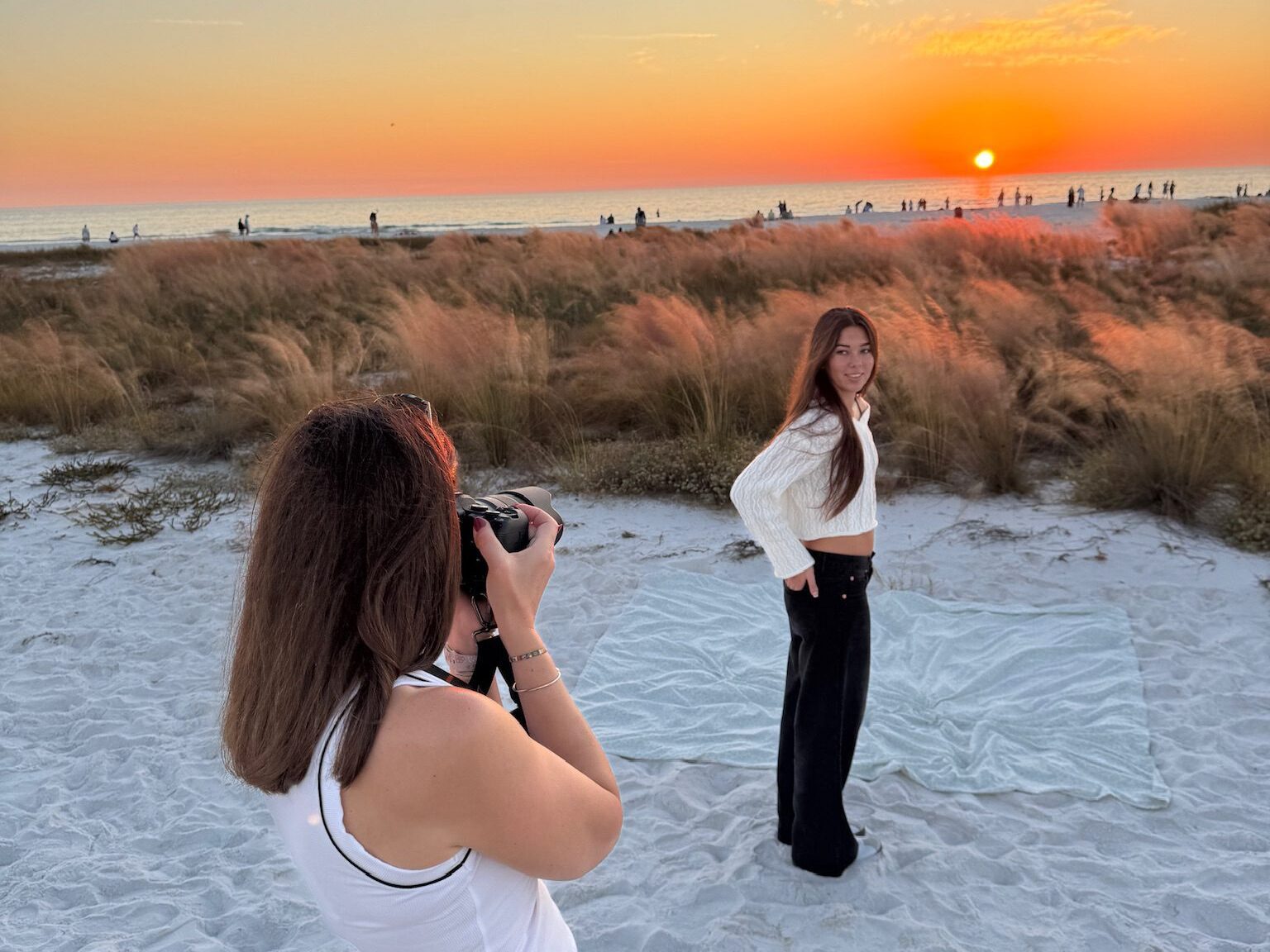 Michaela Ristaino photographing a senior portrait session at Siesta Key beach during sunset, Sarasota FL