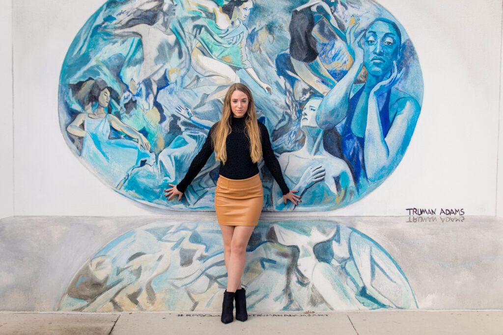 Downtown senior portrait session in front of colorful mural, Sarasota