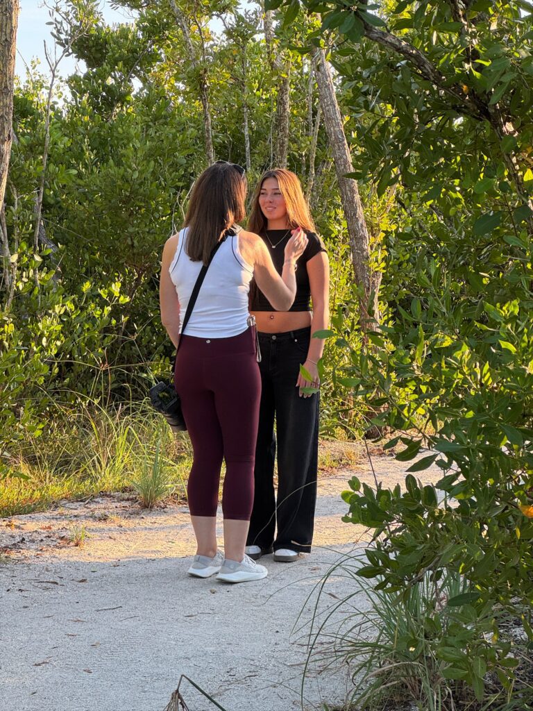 Sarasota senior photographer connecting with client during candid beach portrait session