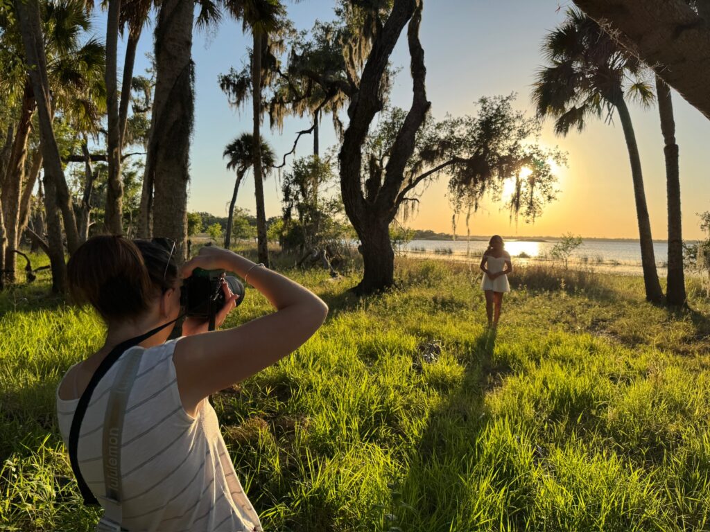 Senior photographer Michaela Ristaino photographing a high school senior at golden hour in Sarasota, Florida