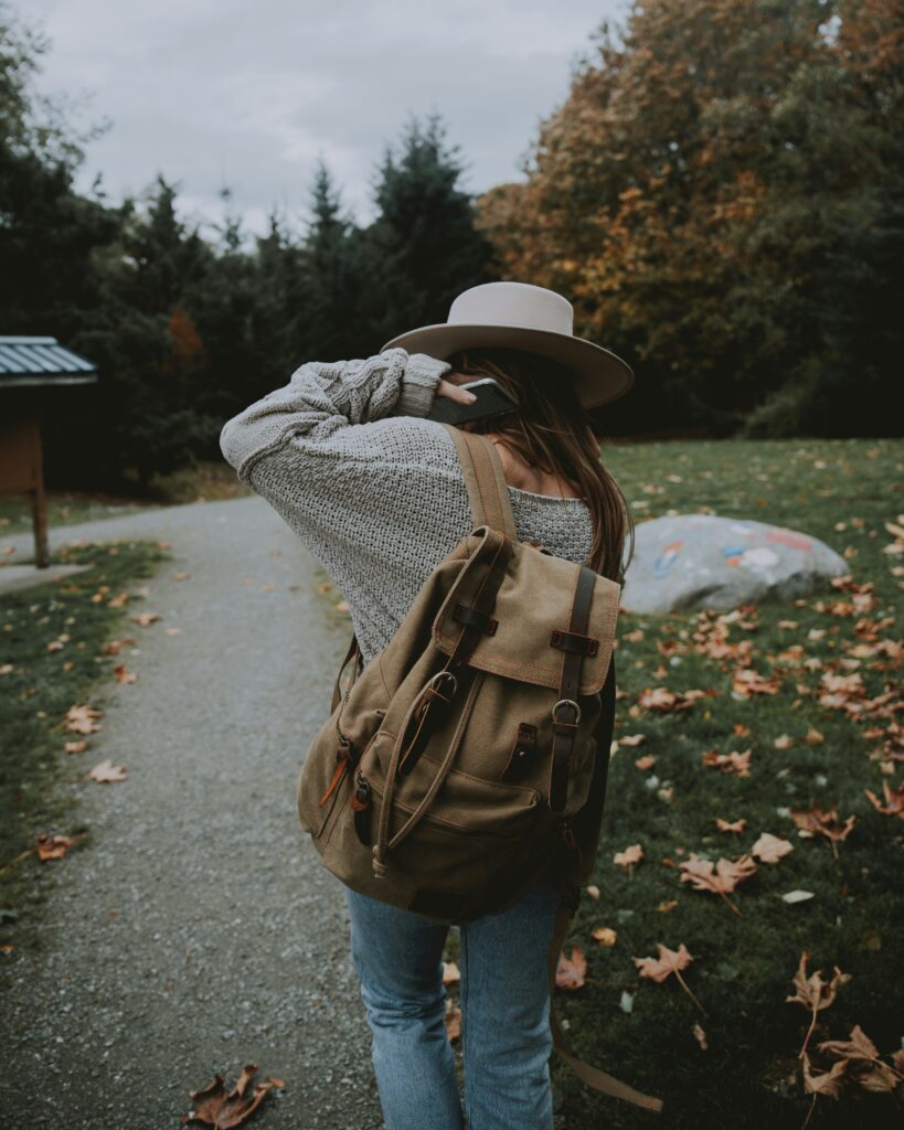 Teen walking away on a path with a backpack, symbolizing the fleeting moments of senior year before graduation