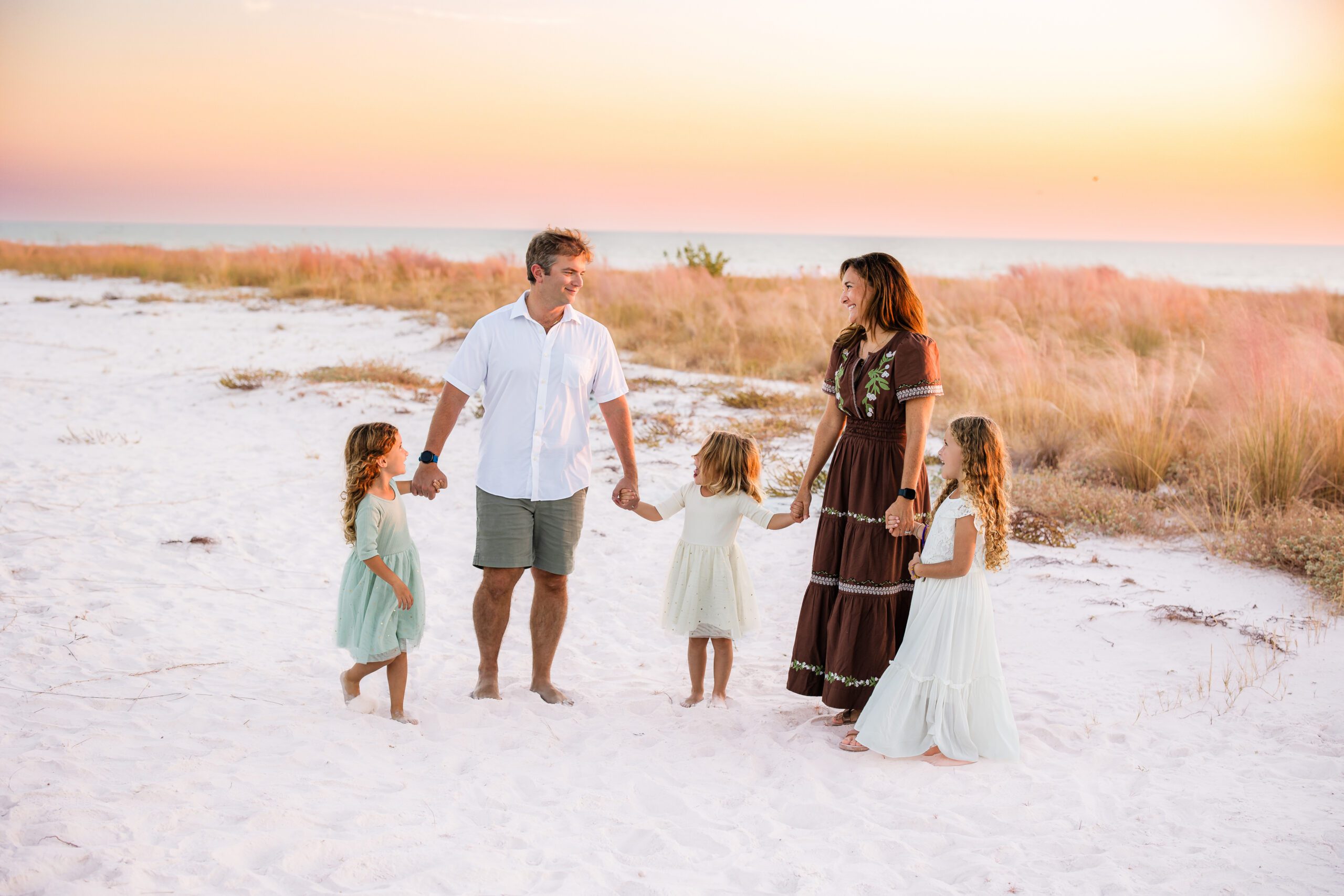 Family of five on Sarasota beach dunes at sunset